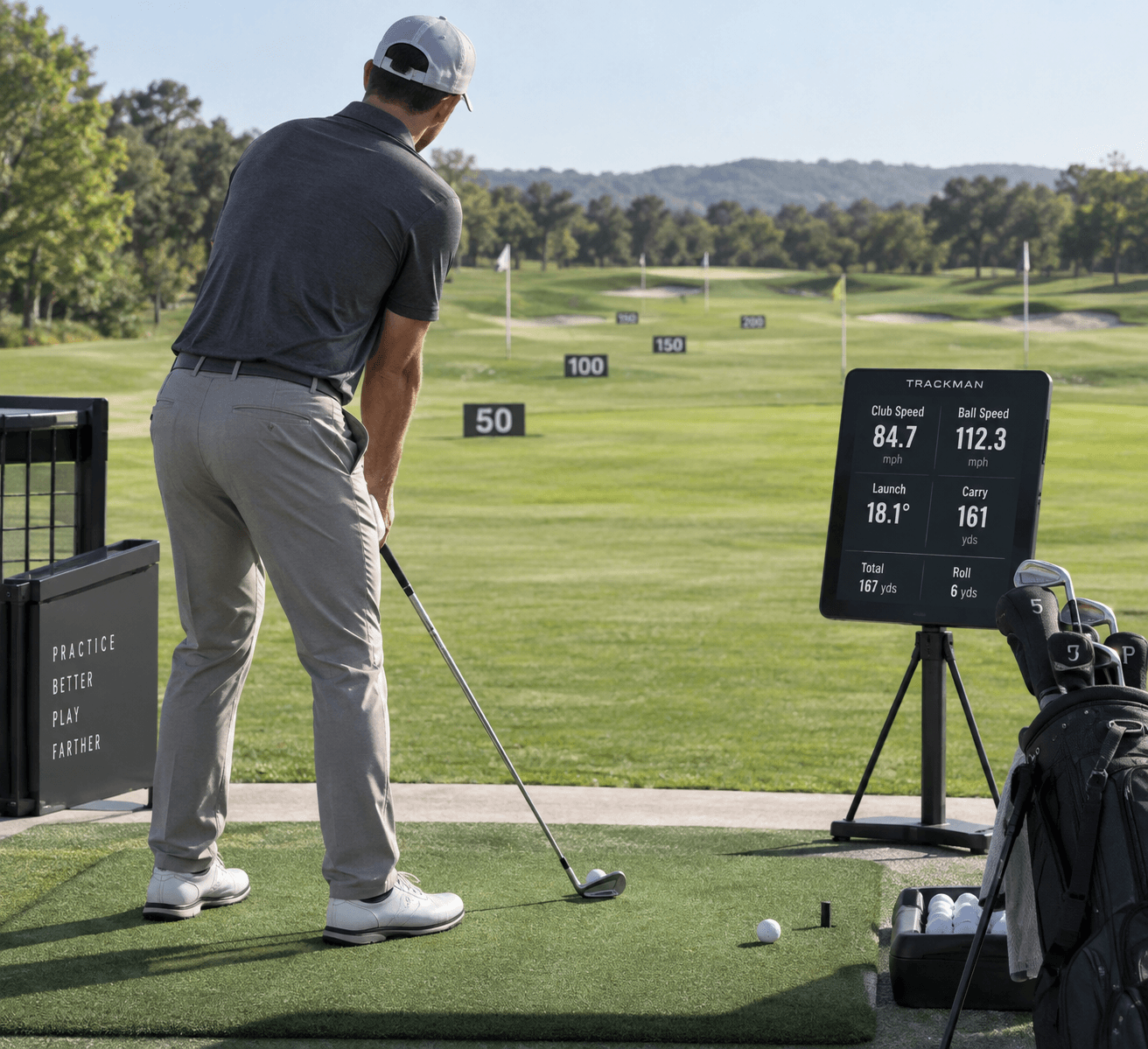 Golfer addressing a ball with 7-iron, launch monitor showing carry data, clubs and targets at a range—iron distances golf