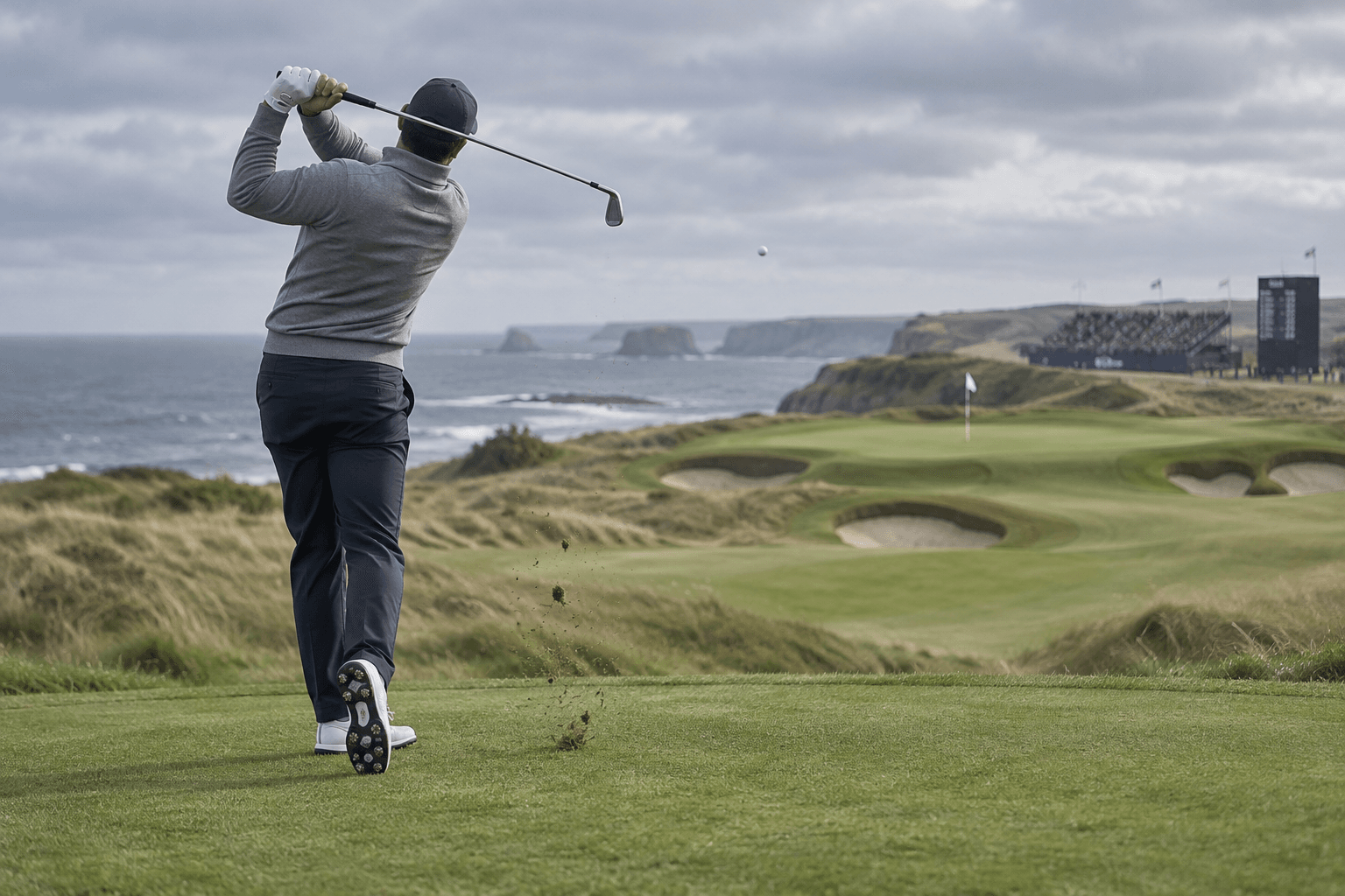 Stenson Golfer: Career, Major Wins, and Playing Style 4 stenson golfer in a balanced follow-through on a coastal links course, with the ball airborne, a flag, bunkers, and sea beyond.