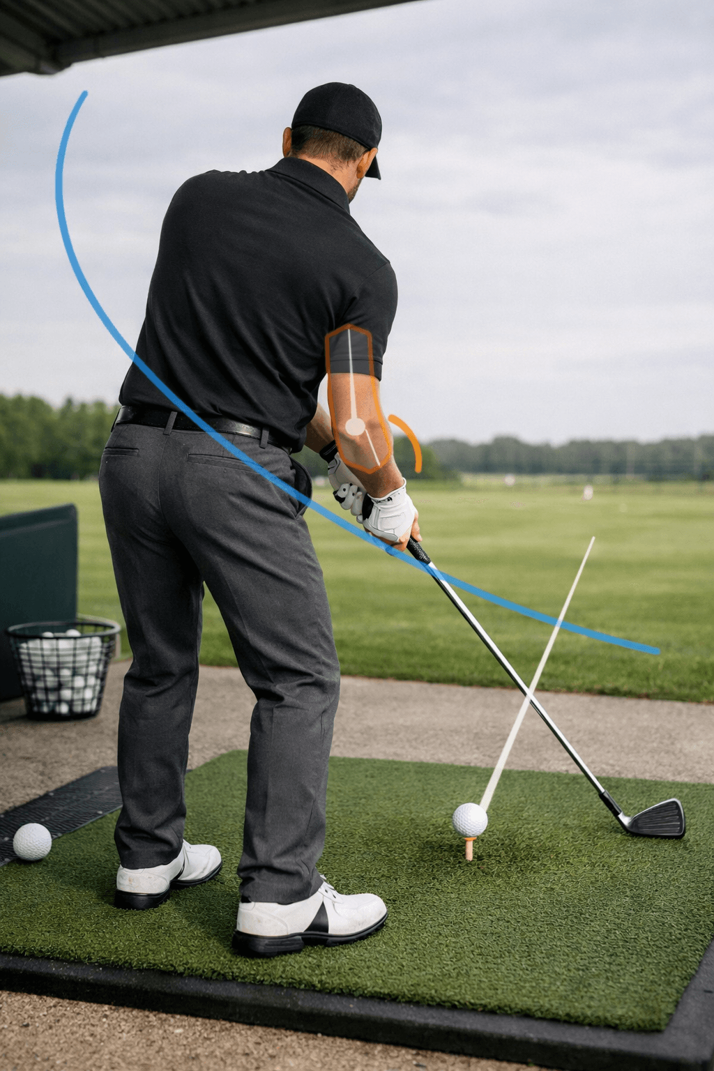 Rear-view golfer at impact with golf elbows aligned, clubface square to the ball, and subtle swing-plane overlays on a driving range